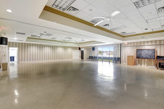 interior space featuring a tray ceiling, a paneled ceiling, concrete flooring, and ceiling fan