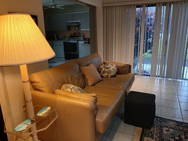 tiled living room featuring ceiling fan