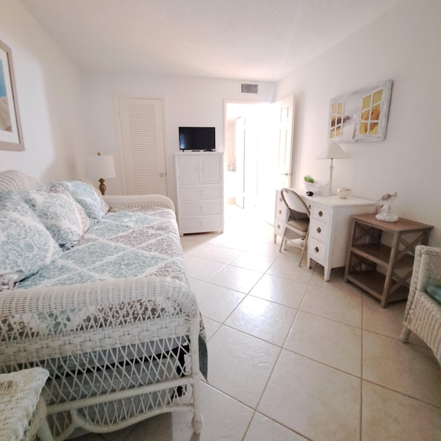 bedroom with a closet and tile patterned floors