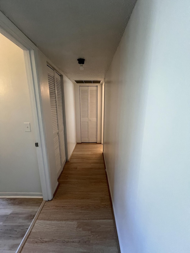 corridor featuring light hardwood / wood-style floors