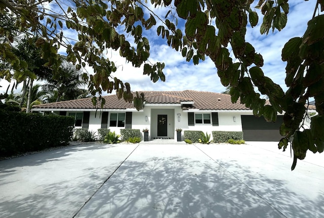 972 Marlin Dr, Jupiter, FL 33458 - ranch-style home featuring a garage, stucco siding, a tiled roof, and driveway