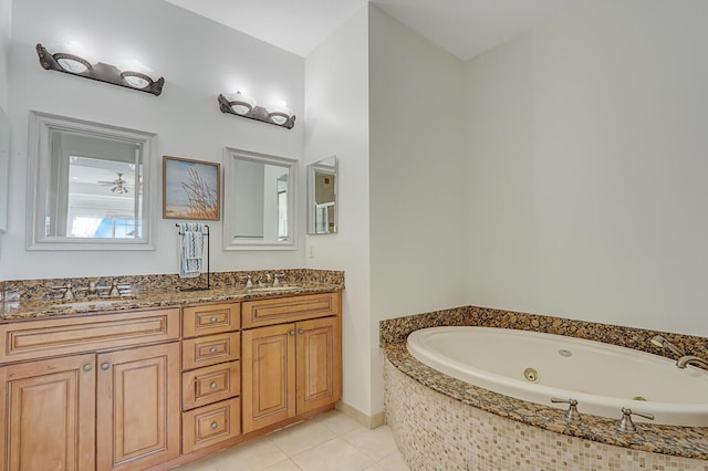 bathroom featuring tile patterned flooring, vanity, and tiled bath