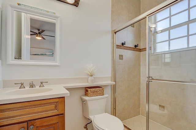 bathroom with vanity, walk in shower, ceiling fan, and toilet