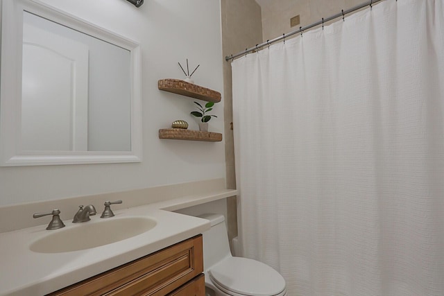 bathroom featuring vanity, toilet, and a shower with shower curtain