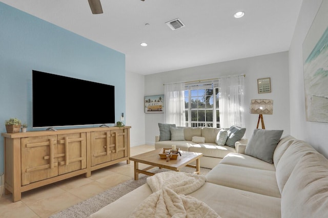 tiled living room with ceiling fan