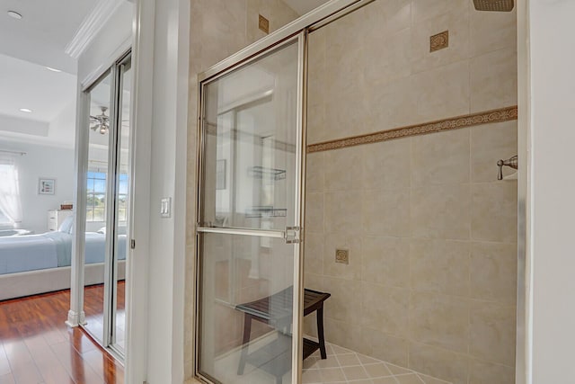 4557 Artesa Way S, Palm Beach Gardens, FL 33418 - ensuite bathroom with a shower stall, wood finished floors, and ornamental molding