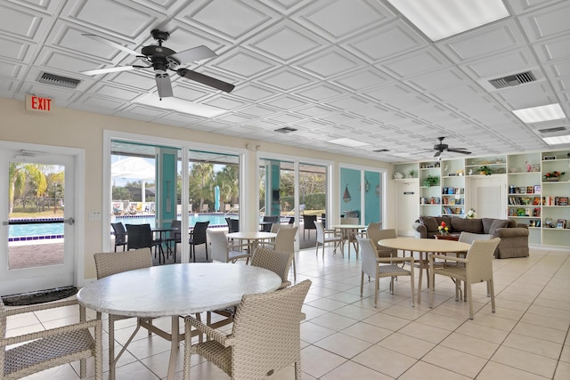 sunroom / solarium featuring ceiling fan and a healthy amount of sunlight