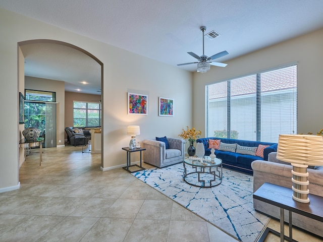 tiled living room featuring ceiling fan