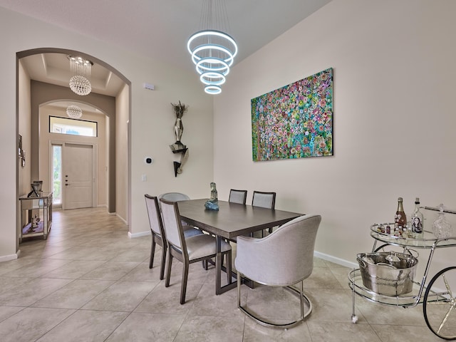 dining space with light tile patterned floors and a notable chandelier