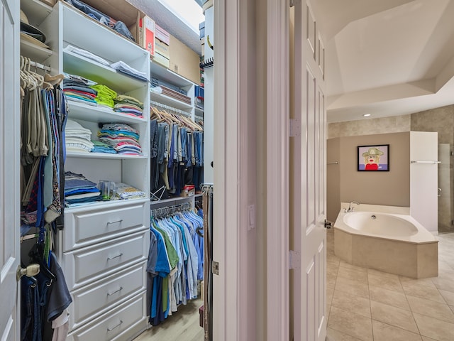 bathroom with a tub and tile patterned flooring