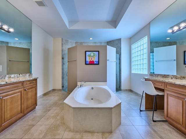 bathroom with a raised ceiling, vanity, tile patterned floors, and shower with separate bathtub