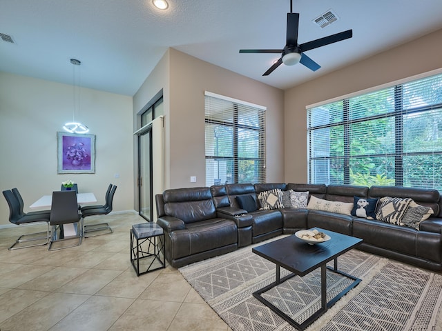 tiled living room with ceiling fan