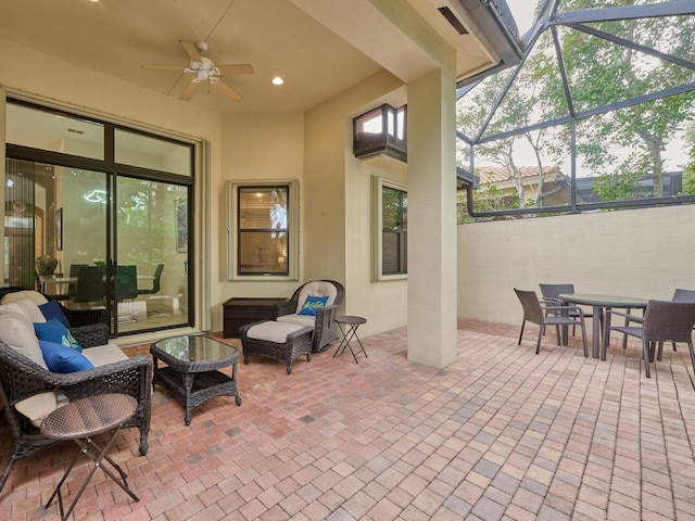 view of patio / terrace with ceiling fan, a lanai, and an outdoor hangout area