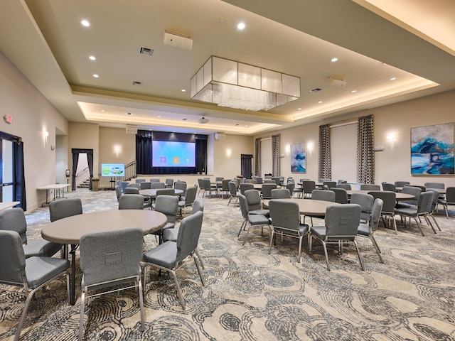 dining room with carpet and a tray ceiling