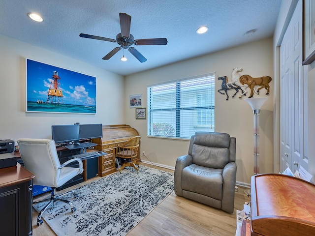 office area with ceiling fan, a textured ceiling, and light hardwood / wood-style flooring