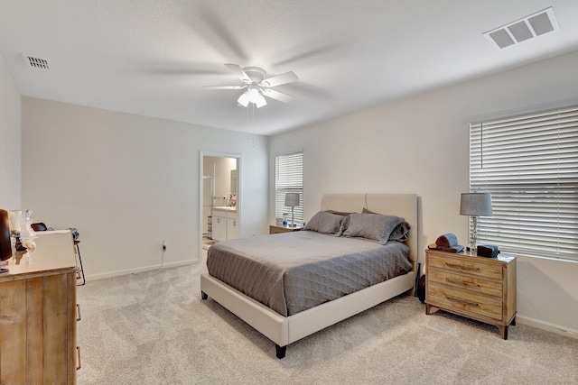 carpeted bedroom with ceiling fan and connected bathroom