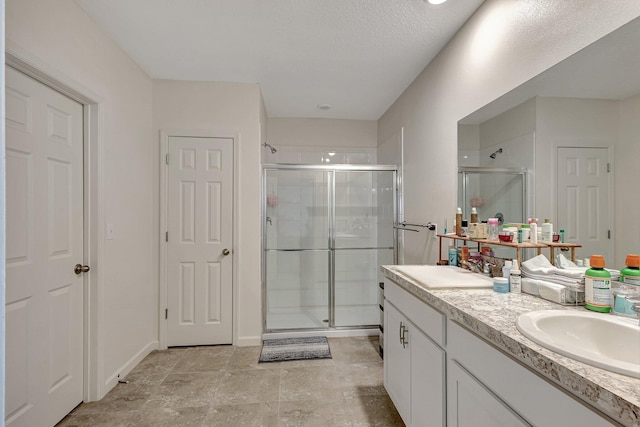 bathroom with vanity and a shower with shower door