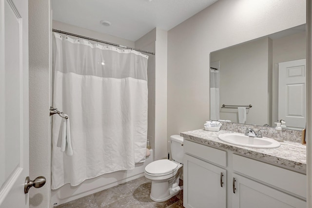 full bathroom with shower / bath combo, vanity, and toilet