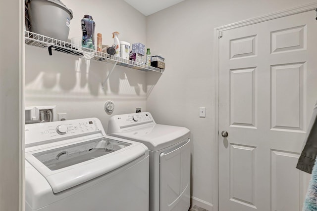 clothes washing area featuring separate washer and dryer