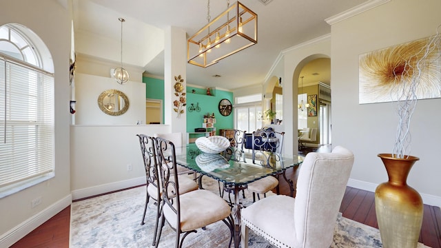 dining area with plenty of natural light, ornamental molding, and hardwood / wood-style flooring