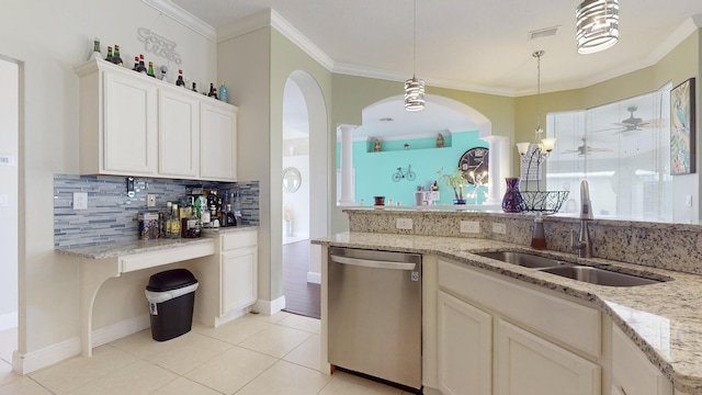 kitchen with decorative light fixtures, stainless steel dishwasher, sink, white cabinetry, and light tile patterned floors