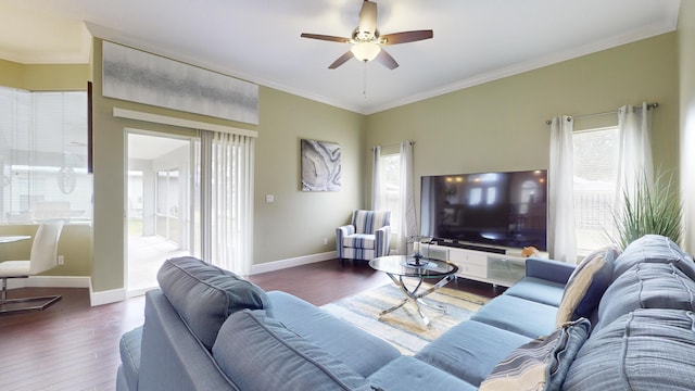 living room with dark wood-type flooring, ornamental molding, and ceiling fan