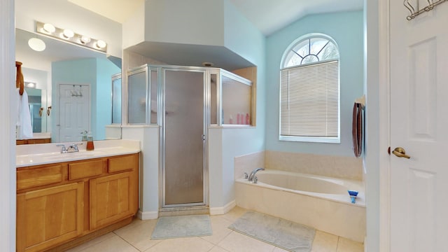 bathroom featuring tile patterned floors, vanity, lofted ceiling, and independent shower and bath