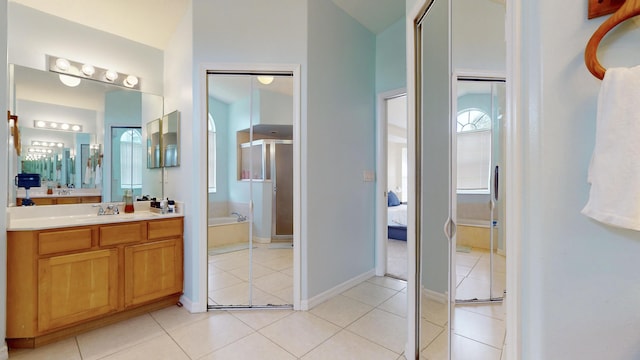 bathroom with plus walk in shower, tile patterned floors, and vanity