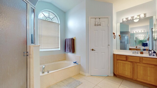 bathroom with tile patterned floors, vanity, lofted ceiling, and independent shower and bath