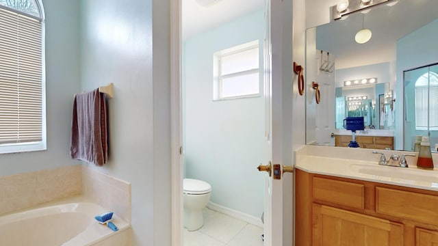 bathroom featuring toilet, tile patterned floors, a relaxing tiled tub, and vanity