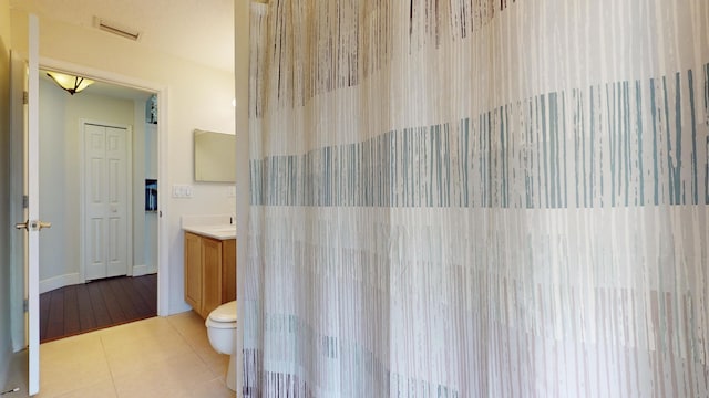 bathroom with tile patterned floors, vanity, and toilet