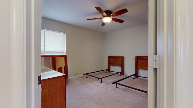 bedroom featuring light carpet and ceiling fan