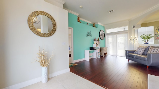 interior space featuring ornamental molding and light hardwood / wood-style floors