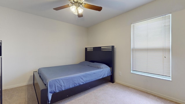 bedroom featuring ceiling fan and light colored carpet