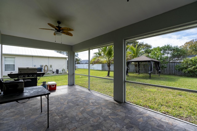 sunroom / solarium featuring ceiling fan