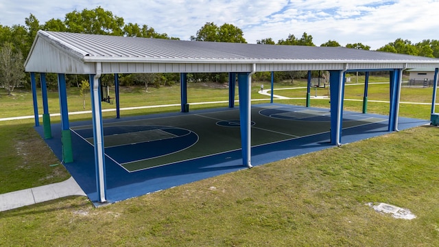 view of sport court featuring a yard