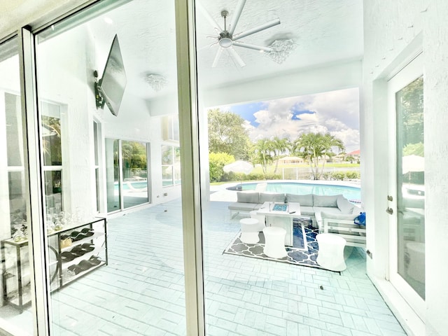 doorway to outside featuring ceiling fan