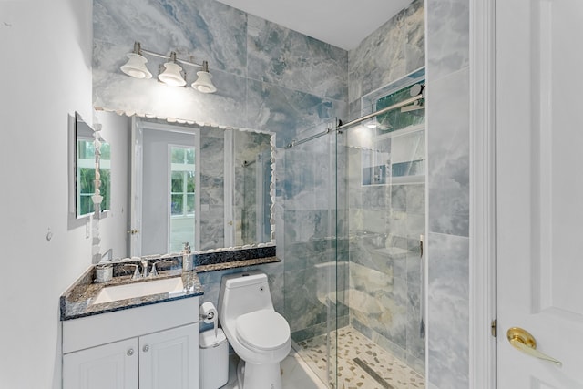 bathroom featuring walk in shower, vanity, and toilet