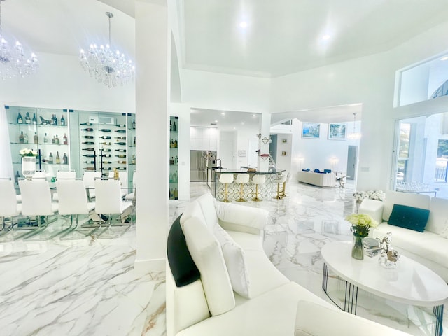 living room featuring a high ceiling and a chandelier