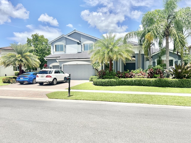 view of front of property featuring a garage and a front lawn