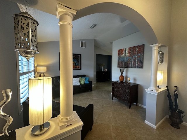 hallway featuring vaulted ceiling and tile patterned flooring