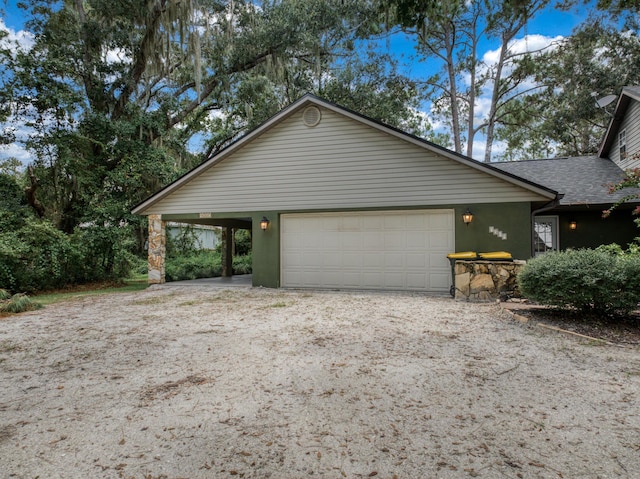 view of front facade featuring an attached garage, a shingled roof, and stucco siding