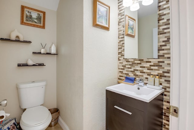 bathroom with toilet, tasteful backsplash, and vanity