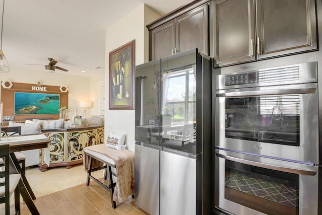 kitchen with ceiling fan, dark brown cabinetry, and stainless steel appliances