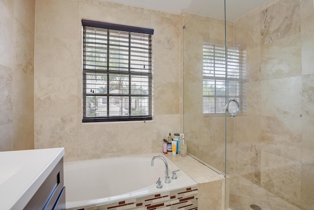 bathroom with independent shower and bath and vanity