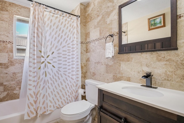 full bathroom with vanity, shower / tub combo, tasteful backsplash, tile walls, and toilet