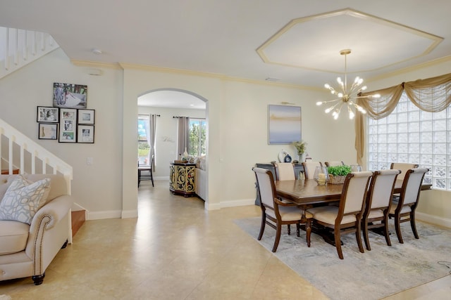 dining area featuring crown molding and a chandelier