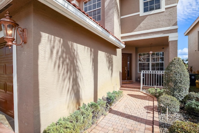 doorway to property with a garage