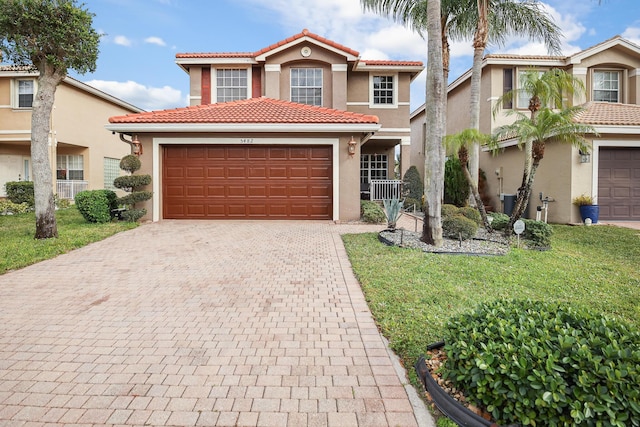 mediterranean / spanish house featuring a garage and a front yard