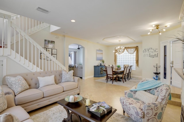 living room with crown molding and a chandelier